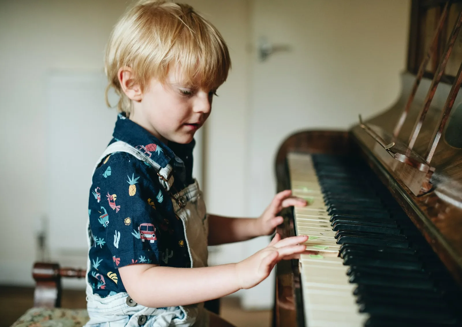 Jeune enfant jouant du piano droit à la maison